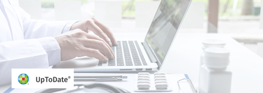 The UpToDate logo superimposed on an image of a physician typing on their computer