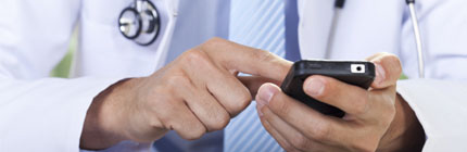 a doctor types on a cell phone