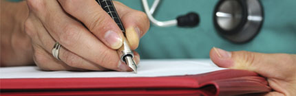 closeup of a doctor writing on a clipboard